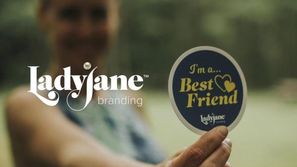 Ladyjane Branding logo and woman holding sticker